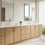 Custom light oak bathroom cabinets with a double vanity and quartz countertop