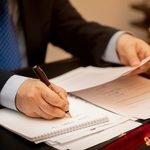 businessman signing important contract papers