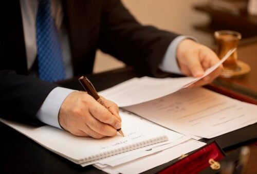 businessman signing important contract papers