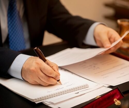 businessman signing important contract papers